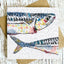 Card with a colorful fish illustration on a wooden surface