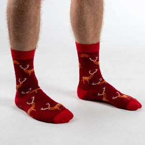 A pair of red bamboo socks with a pattern of deer motifs design.