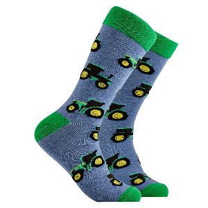 Blue socks with green and yellow tractor patterns on a white background