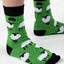 A pair of green and black bamboo socks with a sheep design, worn on a person's feet.