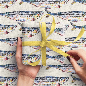 Gift wrapped in colorful fish-patterned paper with a yellow ribbon on a matching background.